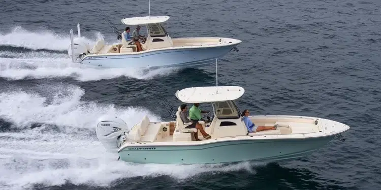 Two Grady White 281 CEs running across water from left to right at near eye-level