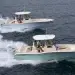 Two Grady White 281 CEs running across water from left to right at near eye-level