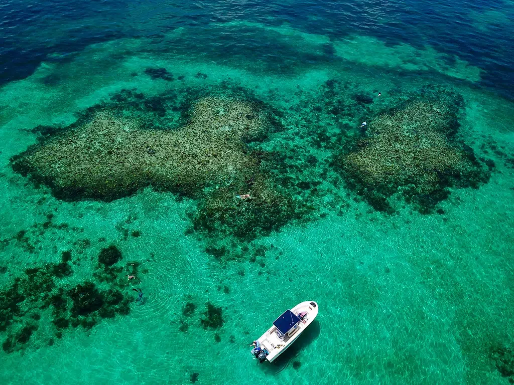 A bird's eye view of a boat anchored at their snorkeling location in the Abacos.