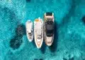 Aerial view of three boats anchored while cruising.