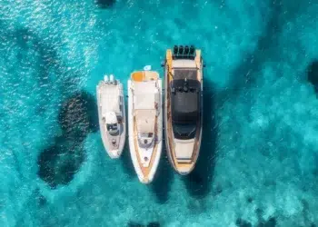 Aerial view of three boats anchored while cruising.