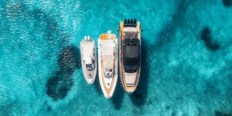 Aerial view of three boats anchored while cruising.