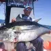 Man holds Large Tuna aboard his center console