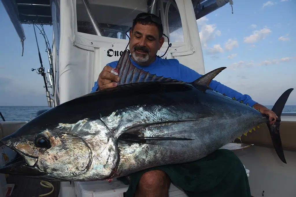 Offshore Fishing Tips success as man holds large tuna