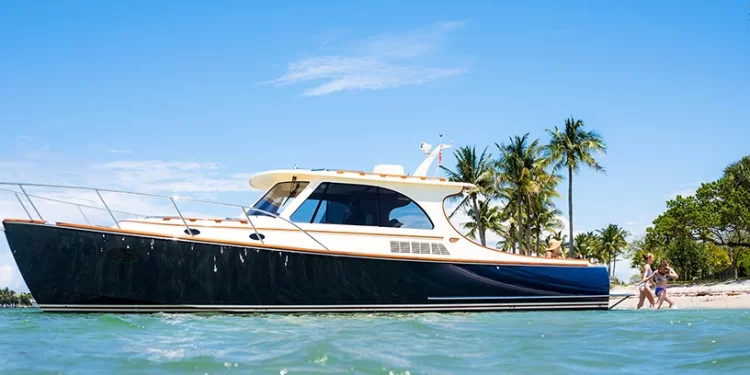 A Hinckley luxury picnic boat on the water by the beach