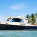 A Hinckley luxury picnic boat on the water by the beach
