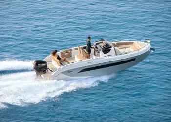 A couple crossing open water on a boat