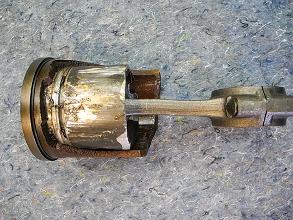 Hydrocked piston and bent connecting rod