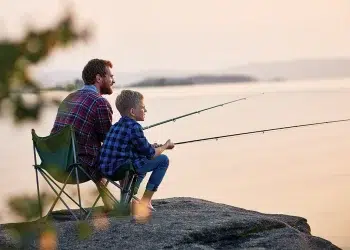 A father teaching a kid to fish