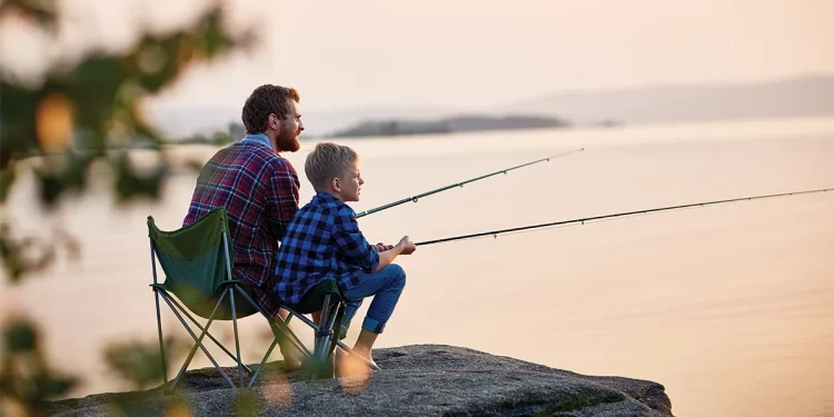 A father teaching a kid to fish