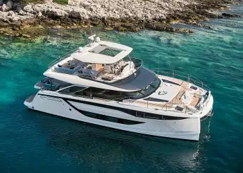 The Prestige M8 Power Catamaran anchored by a cove