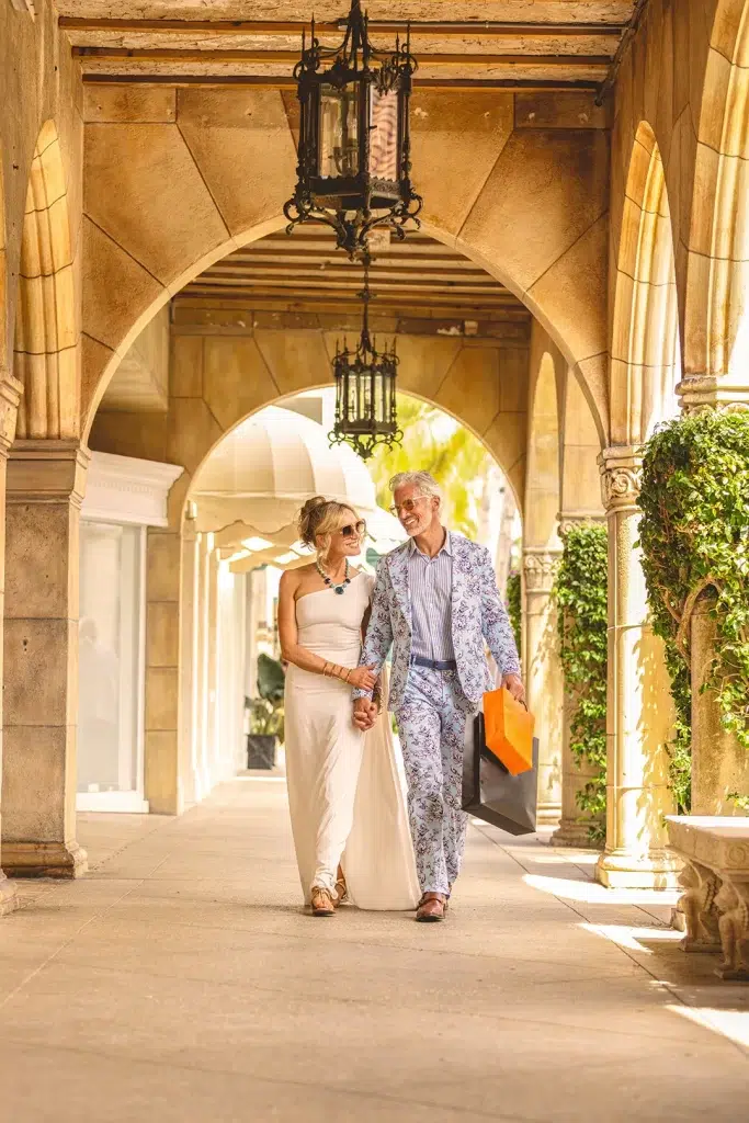 A couple walking the grounds of the town of palm beach marina