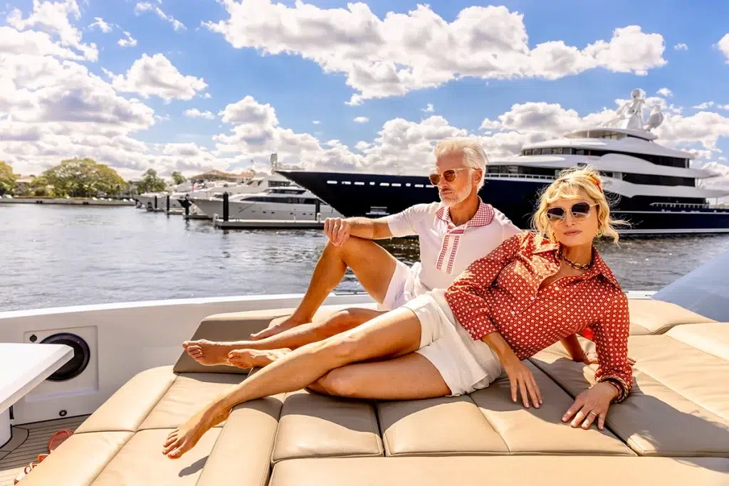 A couple lounging on their yacht while docked at the town of palm beach marina