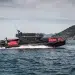 The BRABUS Shadow 1000XC Cross Cabin Black Ops Signature Edition making a sharp starboard turn with a cove in the background