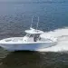 Jupiter 340LS cutting across deep blue open waters