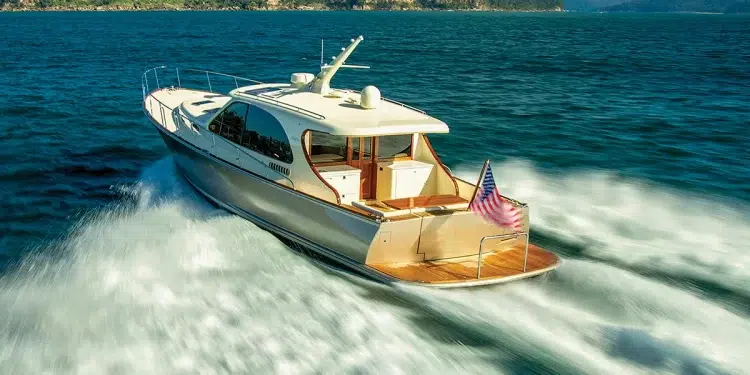 The Stylish Palm Beach PB 55 gliding across water towards an island