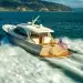 The Stylish Palm Beach PB 55 gliding across water towards an island