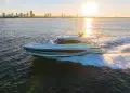 Riviera 6800 Sport Yacht Platinum Edition Running with sun setting behind a cityscape backdrop