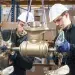 Top Tech For Cruising- Men Installing a Thruster