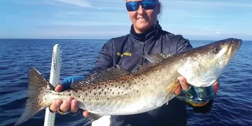 Winter Fishing Tips: An angler holding their catch
