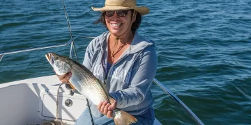 Fish data tracking - an angler poses with a large catch