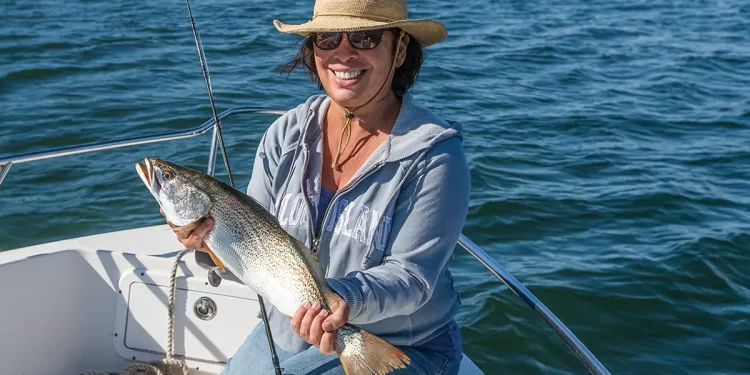 Fish data tracking - an angler poses with a large catch