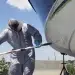 Spring boat prep time - a man washes his hull