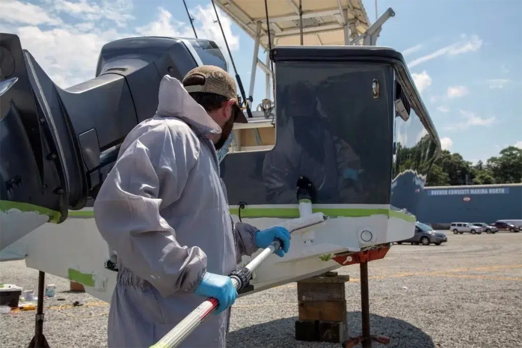 Man cleans a boat as part of his spring time prep