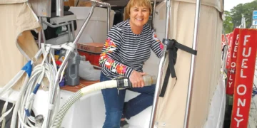 A woman pumps out her boat to prevent marine toilet smells
