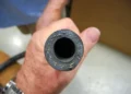 A man holds a clean Marine AC pipe