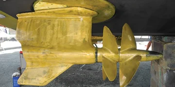 A golden propeller showing the end of this boat's steering system after a DIY project