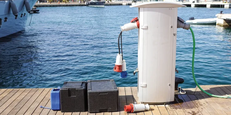 Shore power adapter on a dock with marina water as a backdrop