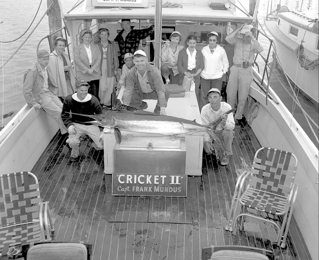 A group of men posing on a boat.