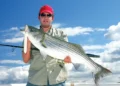 A man holding his catch after using surface lures