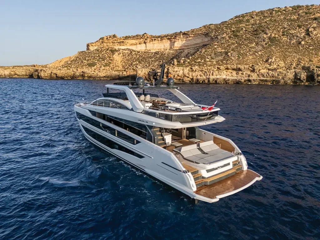 The Pearl 82 yacht anchored close to an island cliff