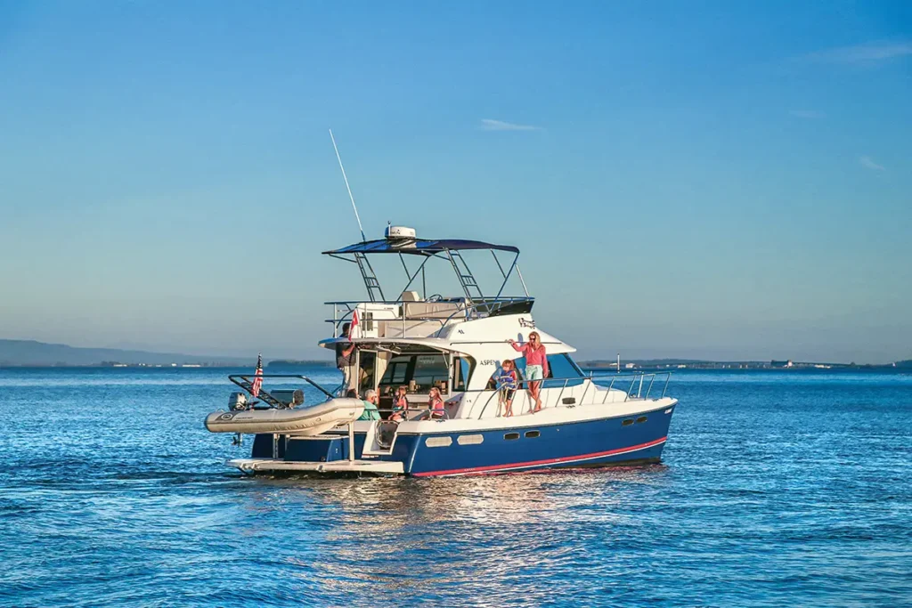 Aspen C120 blue hull in the water with a family on board