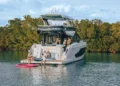 Cruisers FLY 57 idle in the water with a family on board