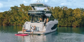 Cruisers FLY 57 idle in the water with a family on board