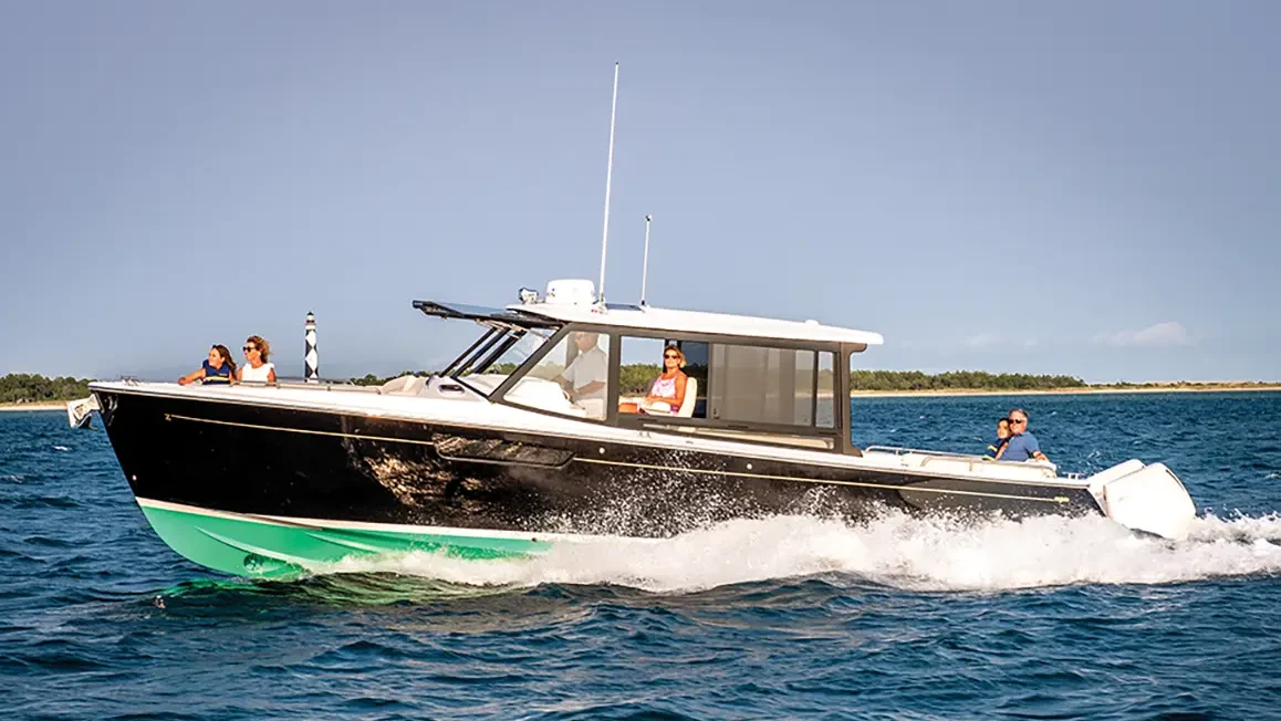 MJM 3 with a green bottom hull running in the water