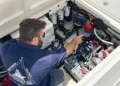 Man applying Seascour descaler to sea strainer on boat engine system
