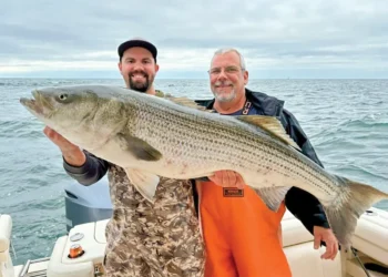 Dieter Herbert and Steve Hochenberger show off the 49.5-inch striper Herbert hooked to win the striper division of the 6th Annual Fall Fishing Showdown last year.