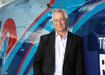 Tropic Ocean Air Founder in front of a helicopter