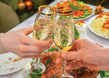 a couple sharing champagne during a holiday boat party