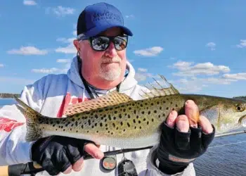 Capt. Gary Dubiel hoists a speck caught on light spinning gear