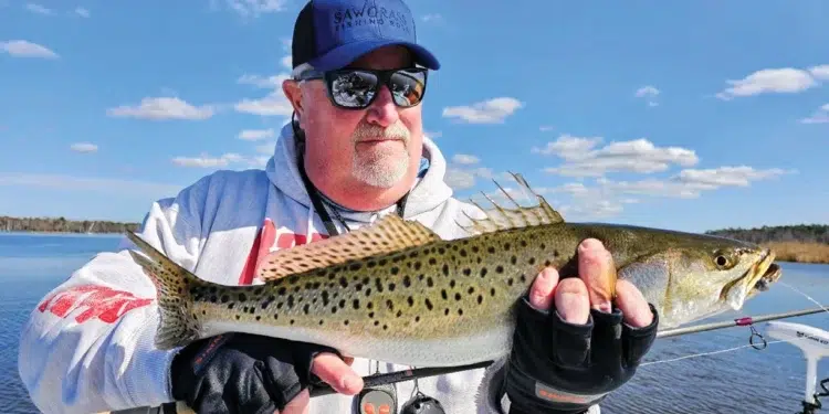 Capt. Gary Dubiel hoists a speck caught on light spinning gear