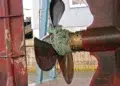 Rope wrapped tight around a boat propeller shaft and running gear