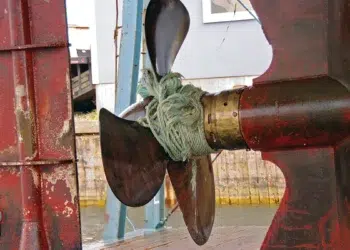 Rope wrapped tight around a boat propeller shaft and running gear