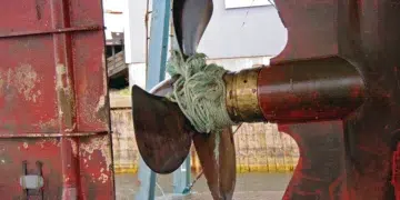Rope wrapped tight around a boat propeller shaft and running gear