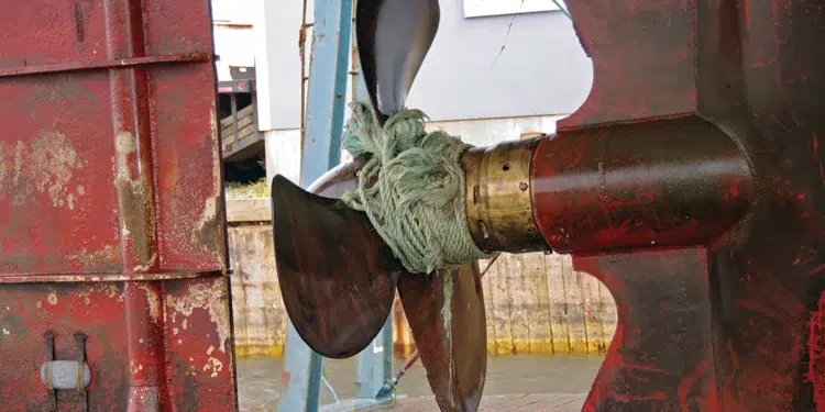 Rope wrapped tight around a boat propeller shaft and running gear