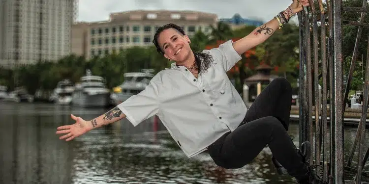 Private yacht chef Robyn Almodovar in chef’s whites at a waterfront gate